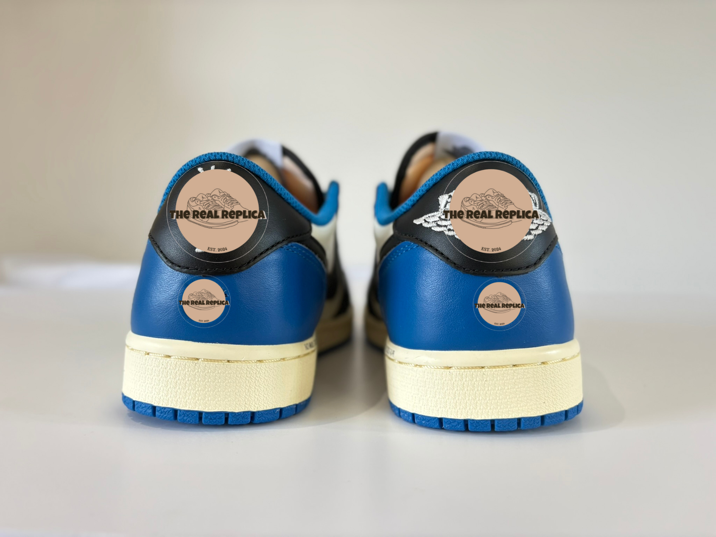 Heel view of our J1 Retro Low - Fragments with white blue and black panels and cream detailing. High quality replica designer trainers UK, affordable trainers, fast delivery, trainer dupes