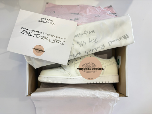 Replica J1 Retro Low P - TS x MR White Party with white leather panels and white tick. Includes dust bag, replica invitation and signature exclusing trainer wrapping. Fake designer trainers UK, designer trainer dupes, high quality replica trainers UK.